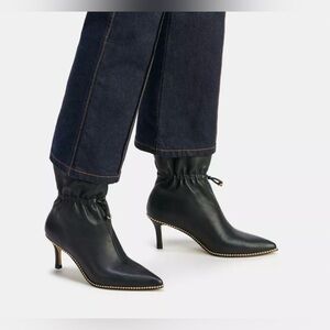 Coach Black Heeled Boots with Gold Accents